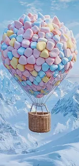 Pastel balloon floating over snowy mountains.