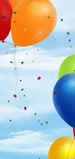 Colorful balloons floating against a bright blue sky background.