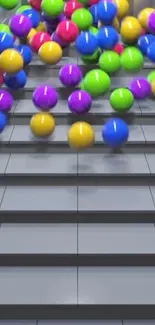 Colorful balls cascading down gray steps.