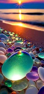 Colorful glass pebbles on a sunset beach near the ocean waves.