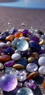 Colorful stones on a sandy beach, ideal for calming mobile wallpaper.