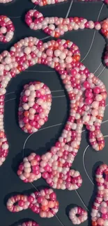 Colorful beads arranged in an artistic pattern on a dark background.