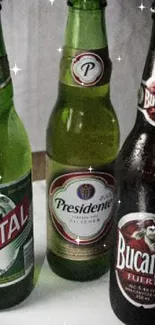 Three colorful beer bottles on display.