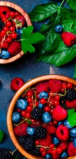 Mobile wallpaper featuring colorful berries in bowls with green leaves.