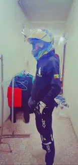 Biker in colorful gear standing in a hallway.