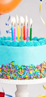 Colorful birthday cake with candles and sprinkles.