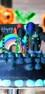 Colorful birthday cake with balloons and rainbow decor.