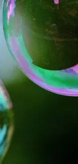 Colorful iridescent bubbles on dark background, mobile wallpaper.