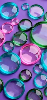 Colorful reflective spheres on purple background.