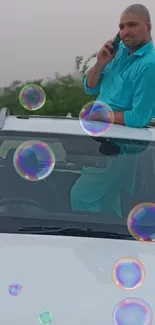 Person on car with colorful bubbles background.