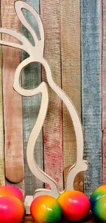 Colorful eggs and wooden bunny on vibrant wallpaper.