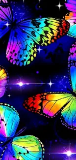 Colorful neon butterflies on dark blue background wallpaper.