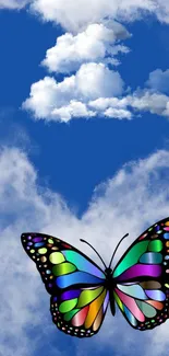 Colorful butterfly on a blue cloudy sky with heart-shaped clouds.