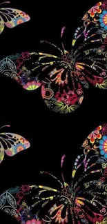 Colorful butterfly pattern wallpaper on black background.