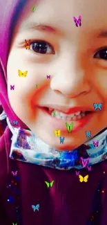 Smiling child with colorful butterflies on face.