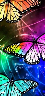 Three vibrant butterflies in neon colors on a dark background.