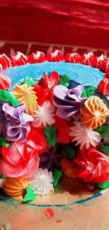 A vibrant floral cake with colorful icing on a red background.