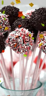 Colorful cake pops in a decorative glass bowl.