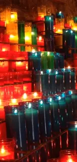 Vibrant display of colorful lit candles.