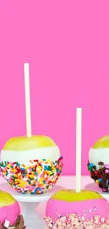 Colorful candy apples with pink background.