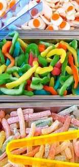 Colorful candy assortment in trays as a phone wallpaper.