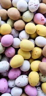 Mobile wallpaper with colorful candy eggs in pastel shades.