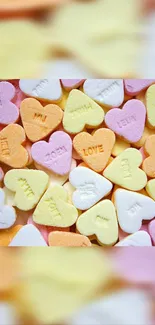 Candy hearts in pastel colors forming a romantic wallpaper.