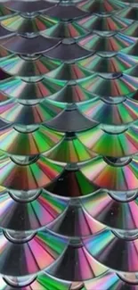 A pattern of overlapping CDs creating vibrant rainbow reflections.