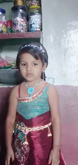 Young girl in traditional colorful dress at home.