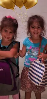 Two smiling children with colorful balloons and bags.