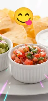 Vibrant plate of tortilla chips with dips on white background.