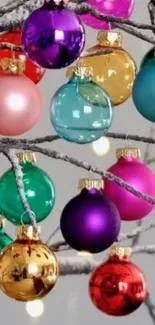 Colorful ornaments hang on frosty branches, creating a festive scene.