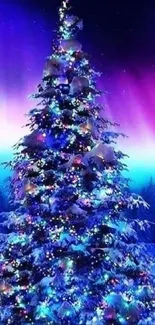 Christmas tree with colorful lights under aurora borealis sky.