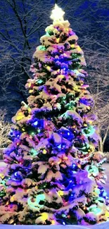 Christmas tree with colorful lights in snowy landscape.