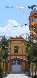 Vibrant church with colorful flags and a sunny sky.