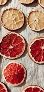 Mobile wallpaper with colorful citrus slices in orange and red hues.