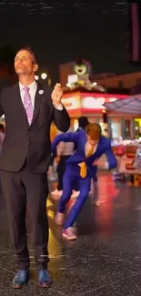 Two men in vibrant suits on a colorful city street at night.