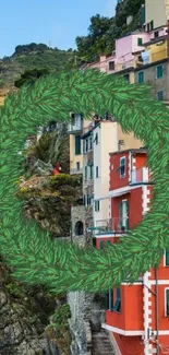 A vibrant cliffside town with colorful buildings and lush greenery in a circle wreath design.