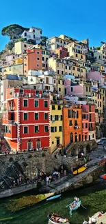 Vibrant cliffside village with colorful houses and boats in the harbor.