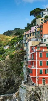 Colorful houses on a coastal cliffside with blue sky.