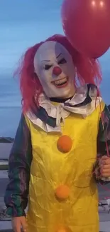 Clown holding red balloon on suburban street at dusk.