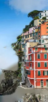 Vibrant coastal town with colorful buildings by the sea under a blue sky.