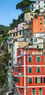 Colorful stacked coastal houses on a cliffside.