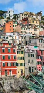 Colorful coastal town with hillside homes and ocean view.