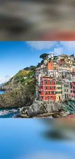 Vibrant coastal village with colorful buildings on a cliff overlooking the ocean.