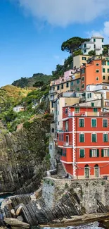 Colorful coastal village with cliffside homes and sea view.