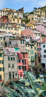 Colorful coastal village with vibrant stacked houses and scenic view.