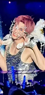 Vibrant stage performer in glittery attire under dynamic concert lights.