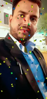 Man in suit with colorful confetti backdrop.