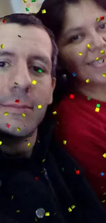 Two people enjoying a confetti shower celebration.